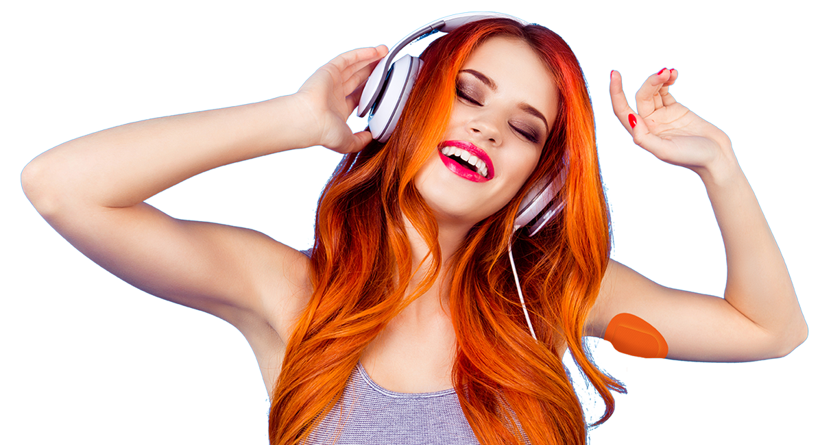 Woman wearing headphones and a CGM patch